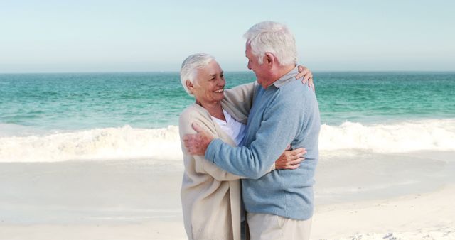 Retired old couple embracing each other on the beach