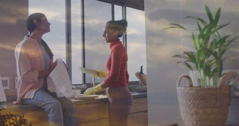 Mother and Daughter Chatting While Drying Dishes in Cozy Kitchen