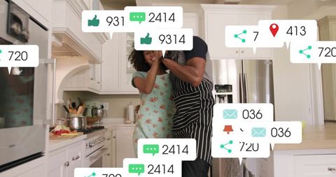 Hugging couple cooking in kitchen with social media icons floating playfully
