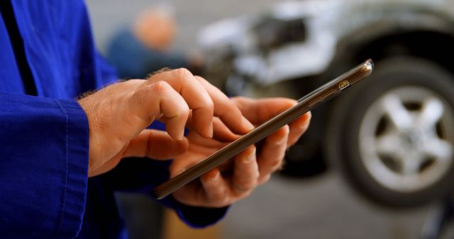 Mechanic Using Tablet for Car Diagnostics in Workshop - Download Free Stock Images Pikwizard.com