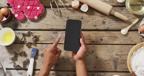 Woman Using Smartphone While Baking on Rustic Wooden Table - Download Free Stock Images Pikwizard.com