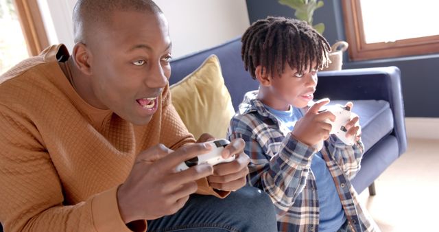 Father and Son Enjoying a Video Game Together in Living Room - Download Free Stock Images Pikwizard.com