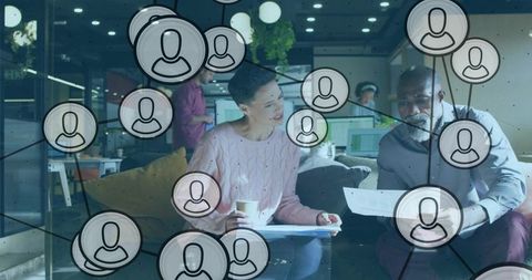 Multicultural team collaborating over documents with network overlay in startup office