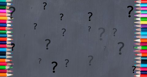Colorful pencils with floating question marks on chalkboard