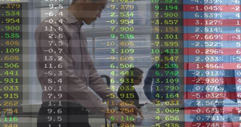Team Analyzing Financial Data on Digital Display in Office