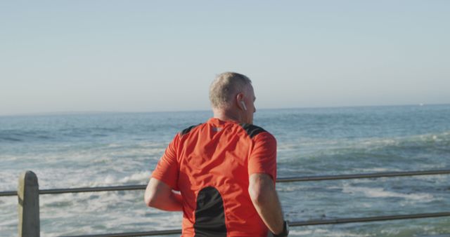 Senior Man Running Along Seaside Promenade in Red Shirt - Download Free Stock Images Pikwizard.com