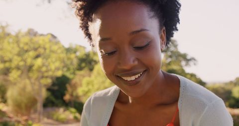 Relaxed Woman Reading Book Outdoors in Sunshine
