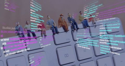 Miniature figures sitting on keyboard with holographic code overlays representing teamwork and codin