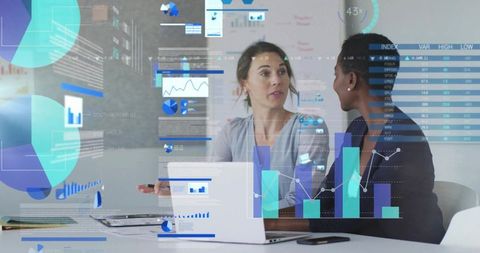 Businesswomen Analyzing Digital Data in Modern Boardroom