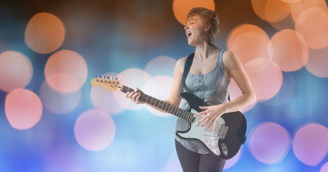 Digital composite of Female music artist playing guitar while singing over bokeh