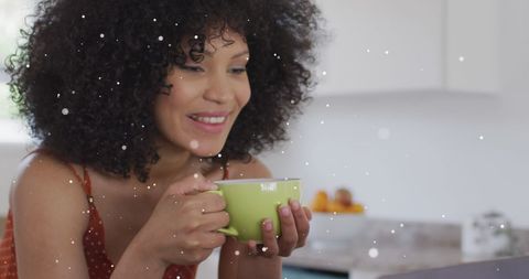 Relaxed Woman Enjoying Coffee in Cozy Kitchen During Winter