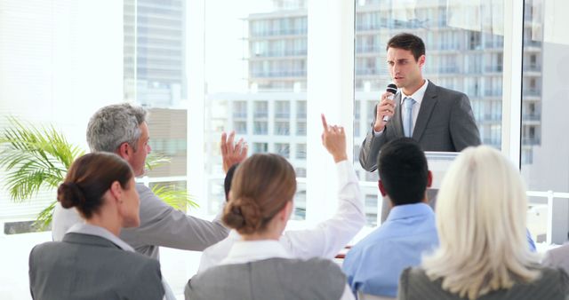 Young Businessman Leading Q&A Session with Engaged Professionals in Modern Office - Download Free Stock Images Pikwizard.com