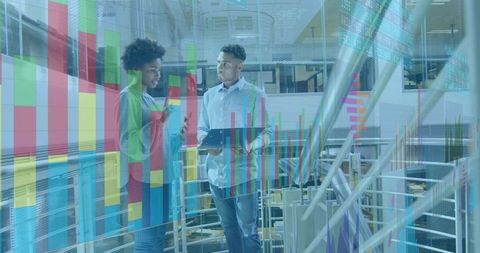 Business team discussing analytics on tablet with data overlays in office atrium