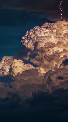 Flashing Lightning Illuminating Towering Cumulonimbus in Indigo Sky | Vertical Storm Video