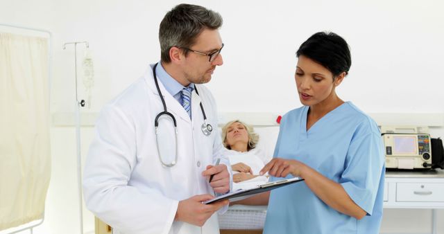 Doctors Discussing Patient's Medical Records in Hospital Room - Download Free Stock Images Pikwizard.com