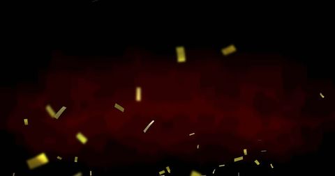 Golden confetti falling on black background for festive celebration