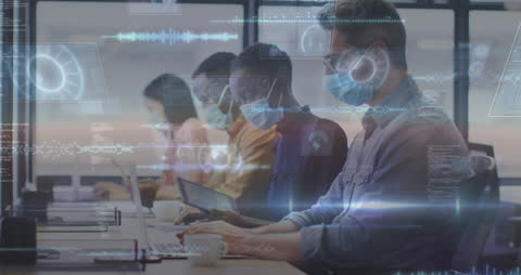 Diverse Team Using Technology in Covid-Safe Office Environment