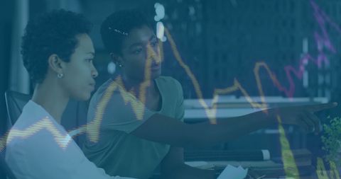 Business professionals analyzing graphic data among global finance trends