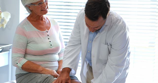 Doctor Examining Senior Woman's Knee in Medical Office - Download Free Stock Images Pikwizard.com