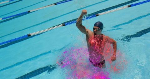 Competitive swimmer celebrating in outdoor pool