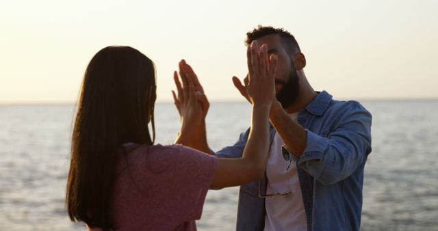 Couple Enjoying Beach Sunset, Playing Clapping Game, Bonding Romantic Time - Download Free Stock Images Pikwizard.com