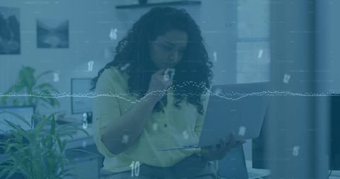 Professional Woman Analyzing Data in Modern Office