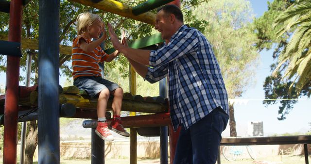 Father and son playing at playground on a sunny day - Download Free Stock Images Pikwizard.com