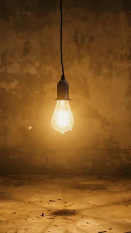 Vintage Filament Bulb Brightening and Fading with Floating Sparks on Plaster Wall Vertical