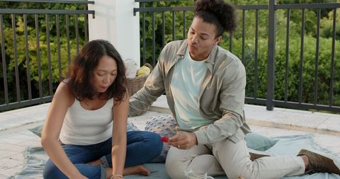 Friends Enjoying Relaxation Time on Balcony with Visible Bonding