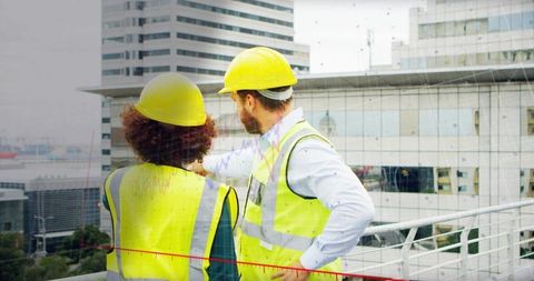 Rooftop construction inspection showing team wearing yellow helmets and safety vests