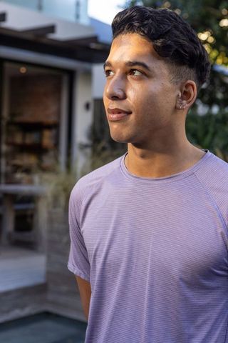 Young Man Relaxing on Contemporary Patio Space with Greenery