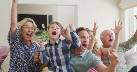 Excited family cheering at home