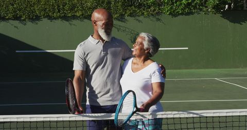 Senior Couple Enjoying Tennis on Sunny Day Outdoors