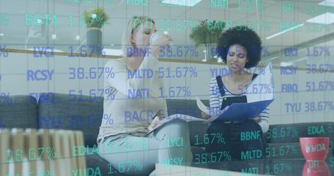 Business Women Analyzing Trend Data in Modern Office Environment