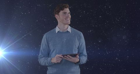 Confident businessman holding tablet in digital universe