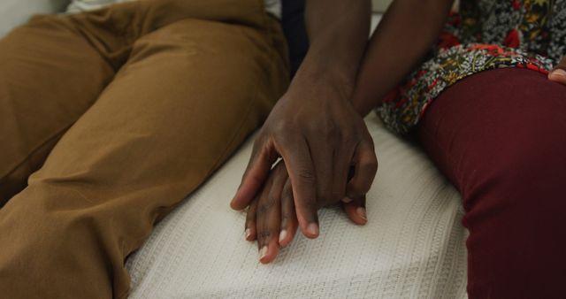 Midsection of african american couple holding hands sitting on sofa - Download Free Stock Photos Pikwizard.com