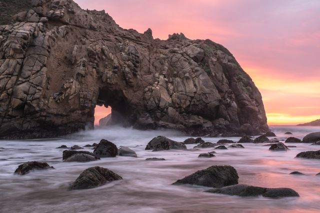 Majestic Rock Formation with Natural Arch at Sunrise Ocean - Download Free Stock Photos Pikwizard.com
