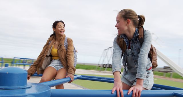 Teen Girls Enjoying Outdoor Playground Carousel - Download Free Stock Images Pikwizard.com