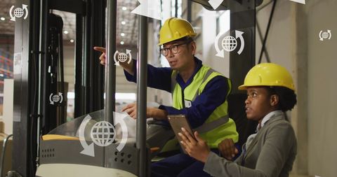 Diverse Engineers Collaborating in Warehouse with Digital Interface Overlay