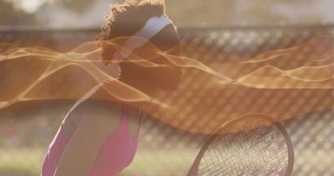 Female Tennis Player Preparing for Shot on Sunny Outdoor Court