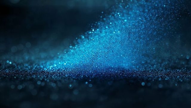 Blue Glitter Shimmering on Dark Surface with Bokeh Illumination