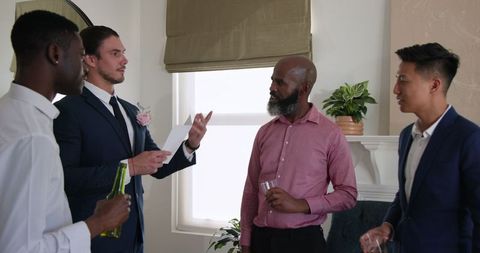 Friends gathering for indoor celebration with drinks and laughter