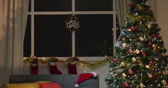 Image of christmas greetings, decorations, christmas tree, lights and christmas stockings at home. christmas, tradition and celebration concept.