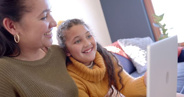 Happy Mother and Daughter Smiling Together While Using Laptop at Home - Download Free Stock Images Pikwizard.com