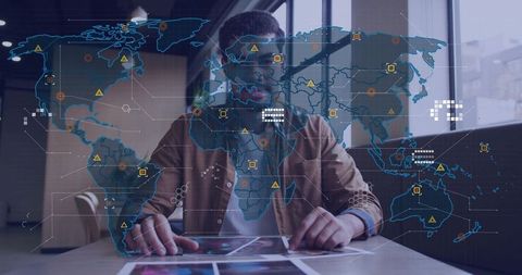 Business analyst using tablet with holographic world map and interactive data dashboard