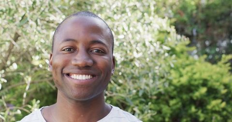 Smiling Young African American Man in Lush Outdoor setting - Download Free Stock Images Pikwizard.com