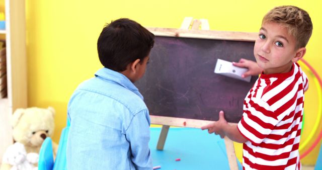 Two Boys Drawing on Chalkboard in Playroom - Download Free Stock Images Pikwizard.com