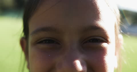 Close-Up of Biracial Schoolgirl Smiling Brightly