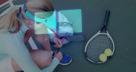 Female athlete preparing for tennis on outdoor court