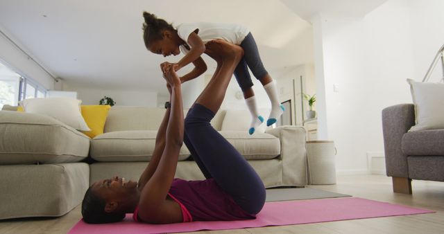Mother and child engaging in playful exercise at home, emphasizing the importance of family bonding, physical fitness, and active lifestyle. Perfect for advertisements promoting family activities, health and wellness campaigns, parenting blogs, and home fitness programs.